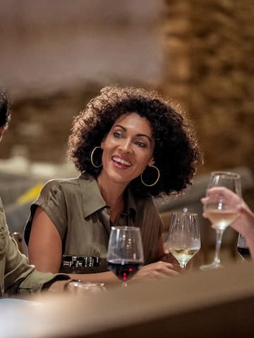 a group of people sitting at a table with wine glasses