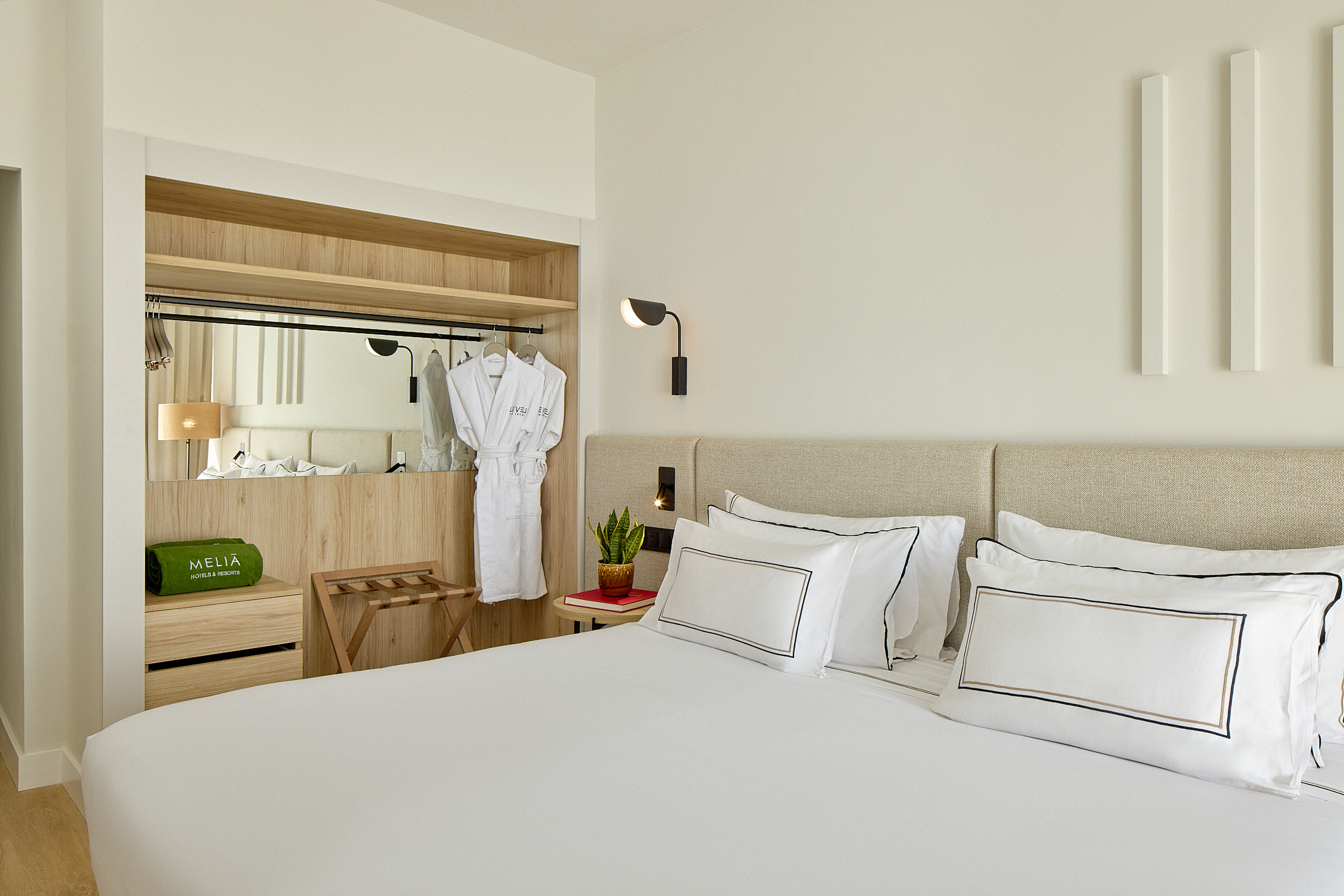 a bed with white sheets and white towels