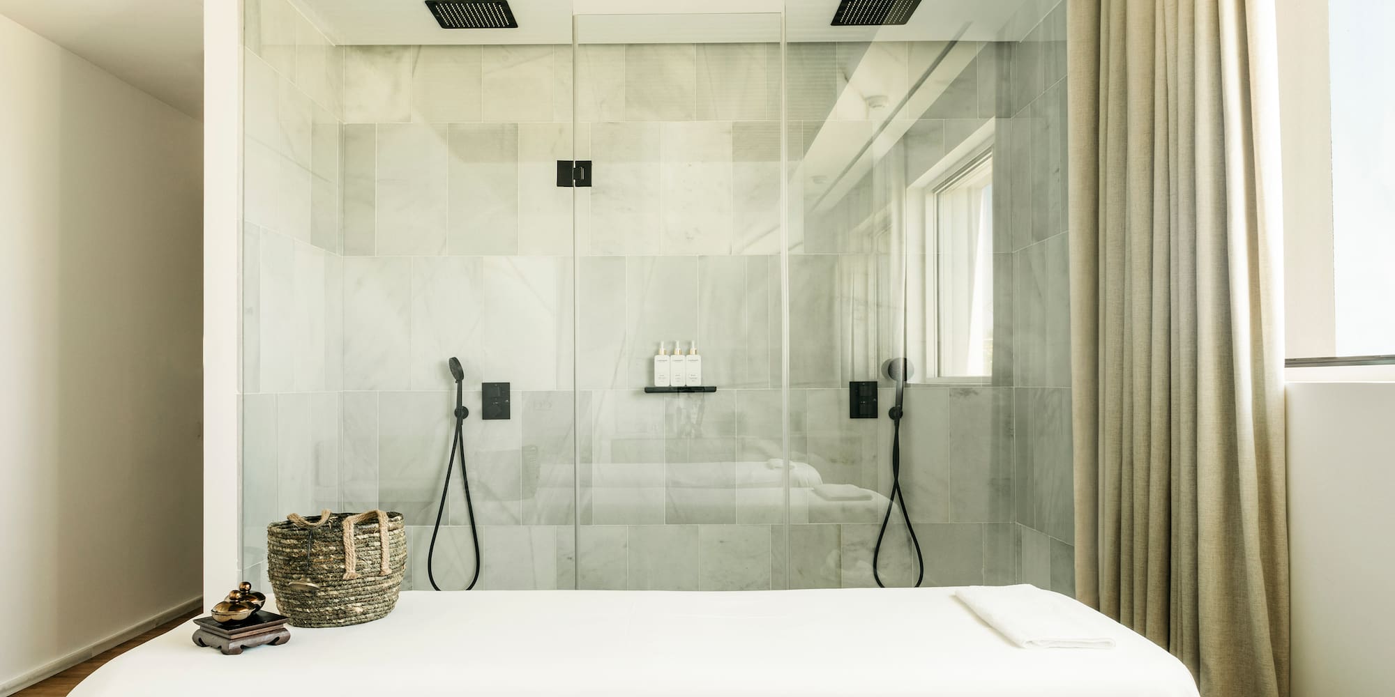 a shower with a bed and a basket