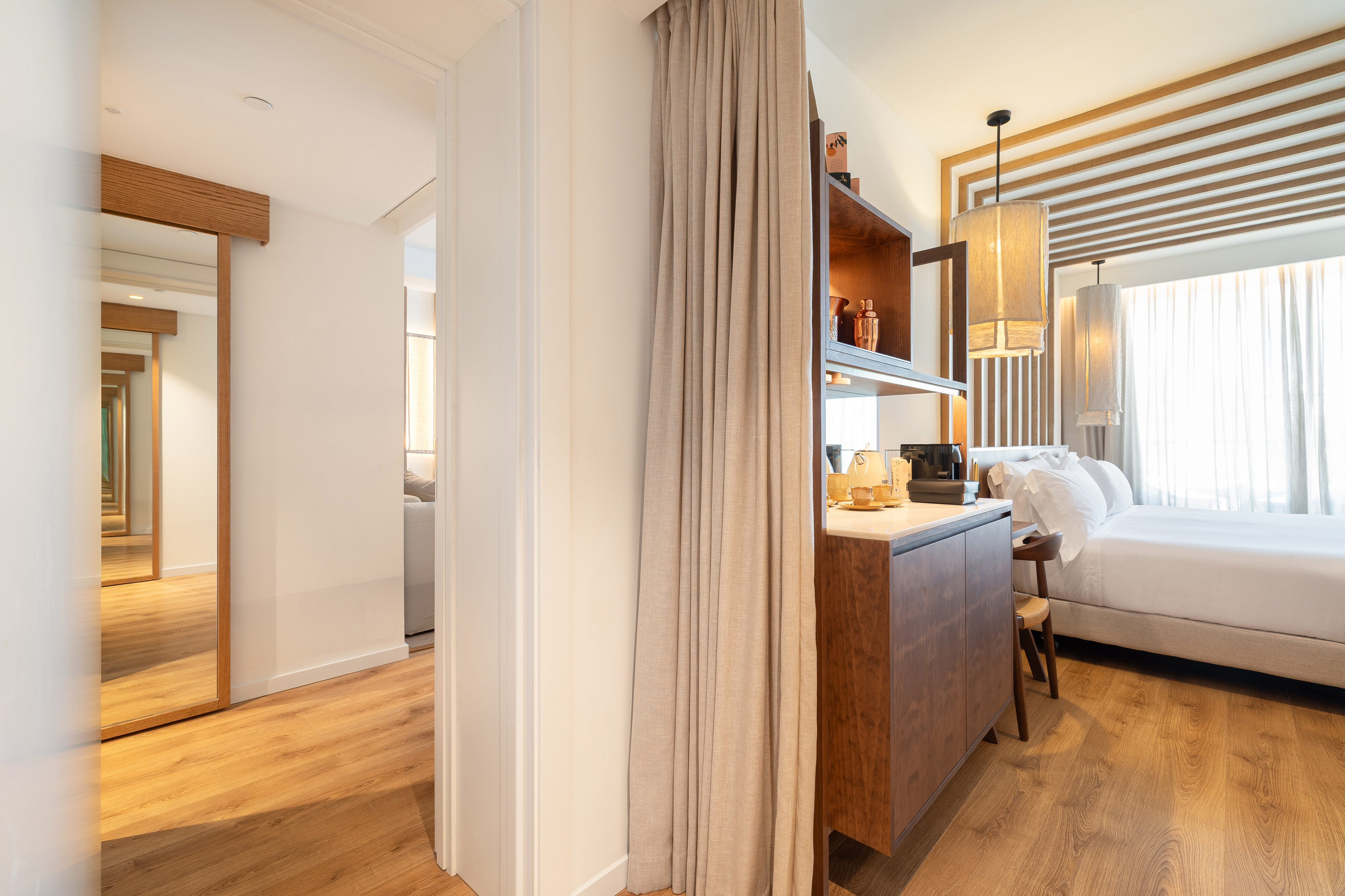 Modern hotel bedroom with mini-bar, wood floor, and elegant lighting. - Always ME Connecting - ME Marbella, Marbella