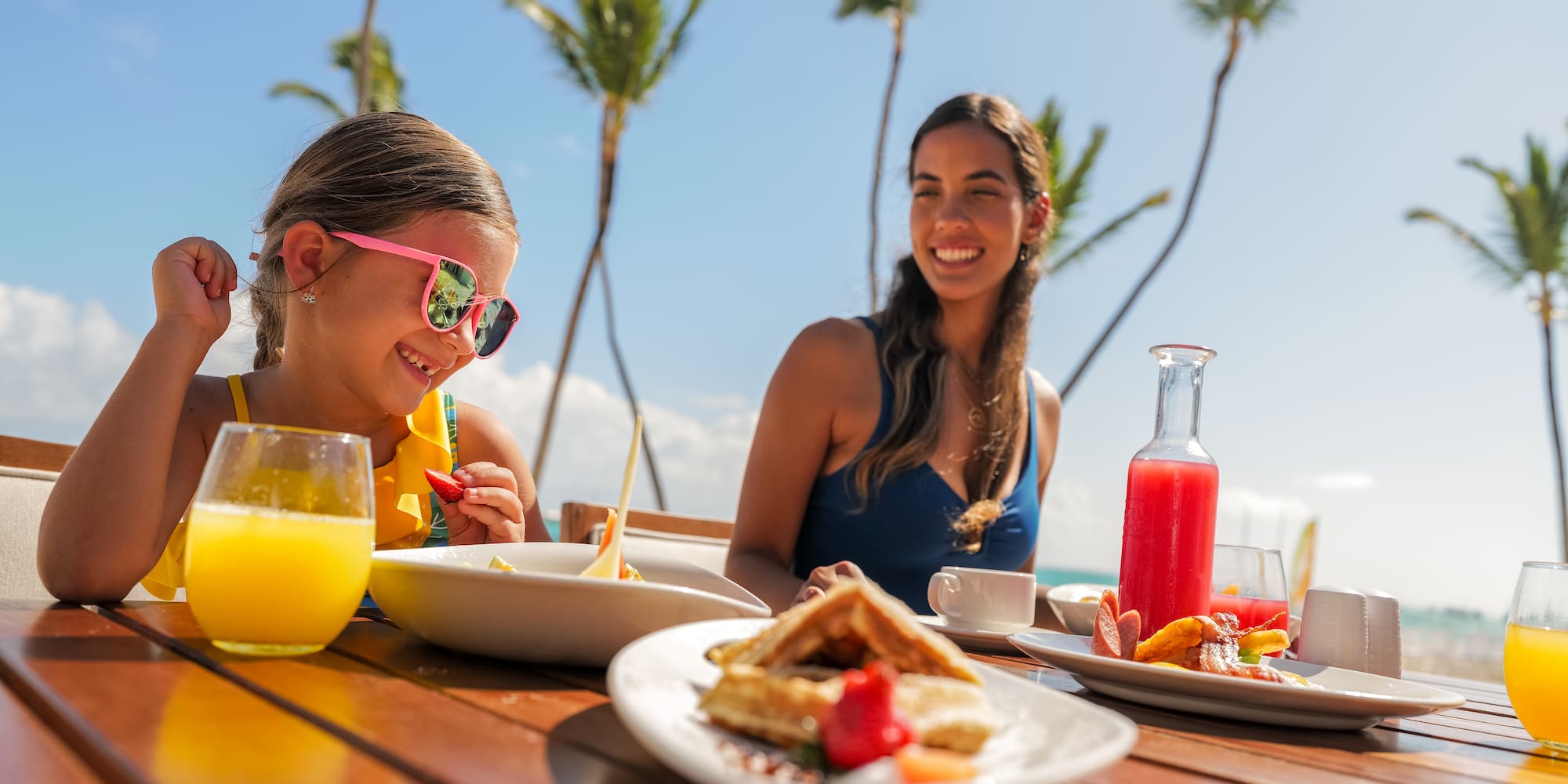a woman and a girl eating at a table