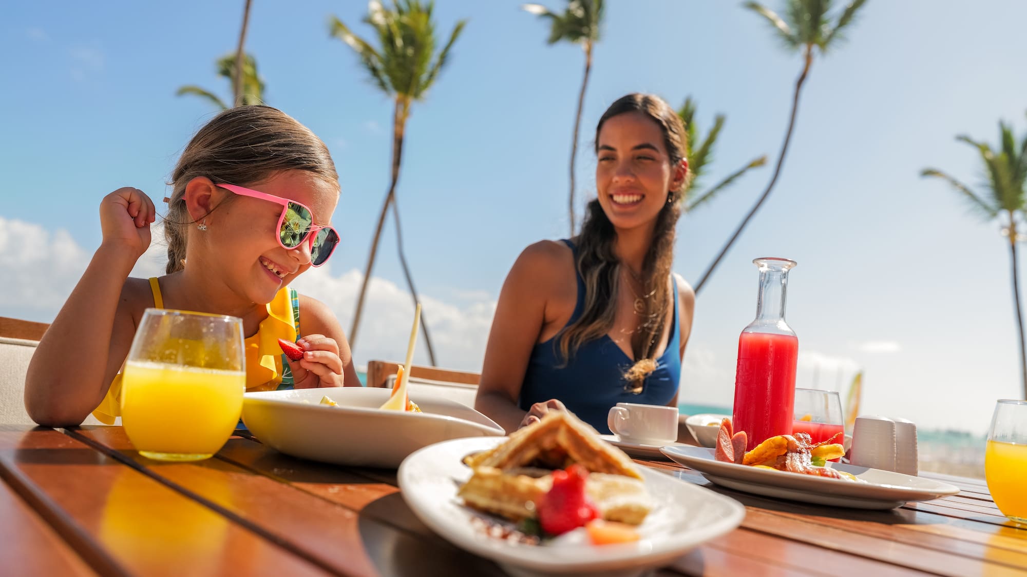 a woman and a girl eating at a table