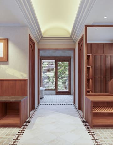 a hallway with wood cabinets and a white floor