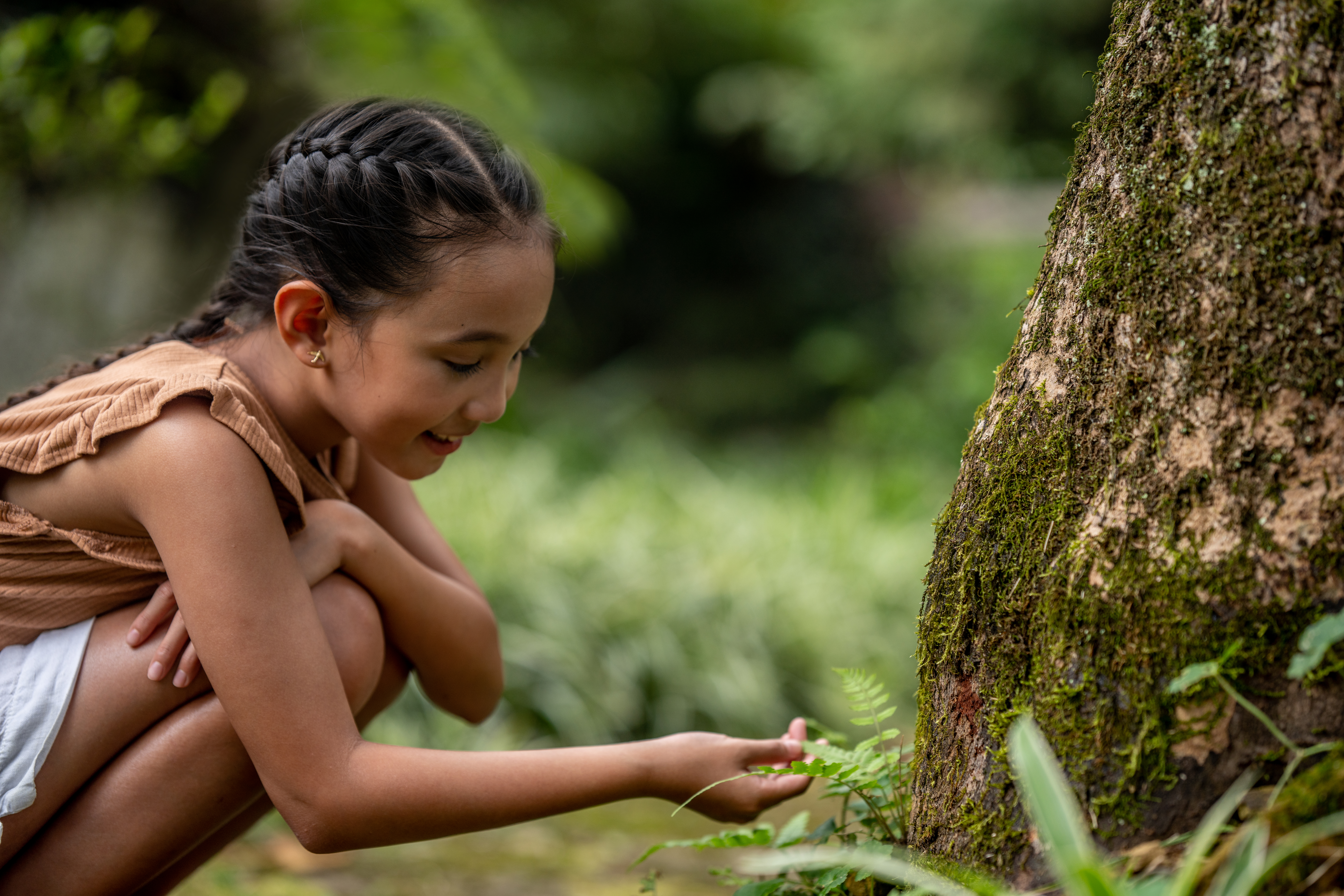 a girl touching a plant