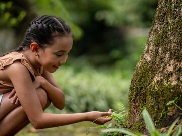 a girl touching a plant