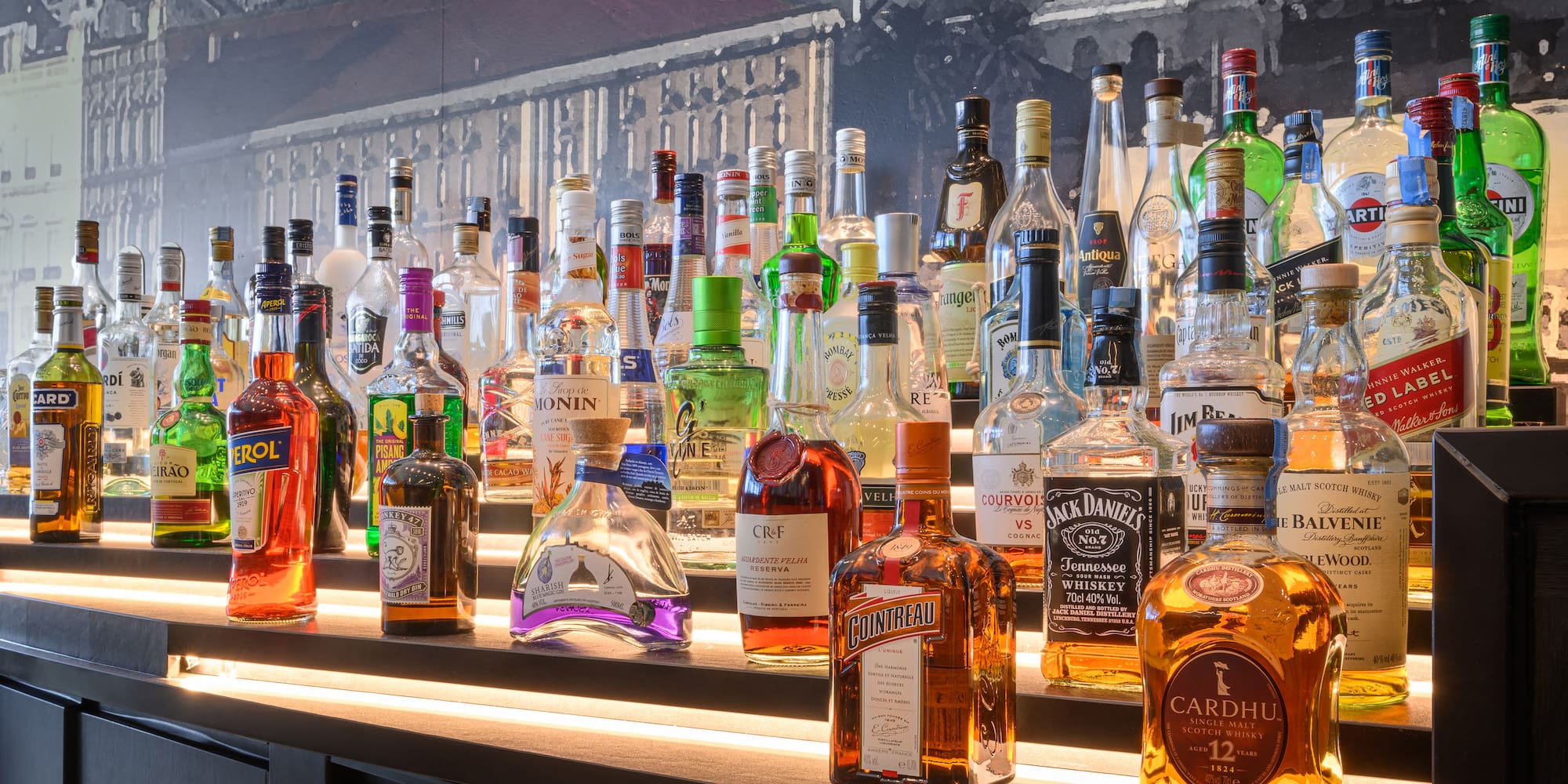 a group of bottles of alcohol on a shelf