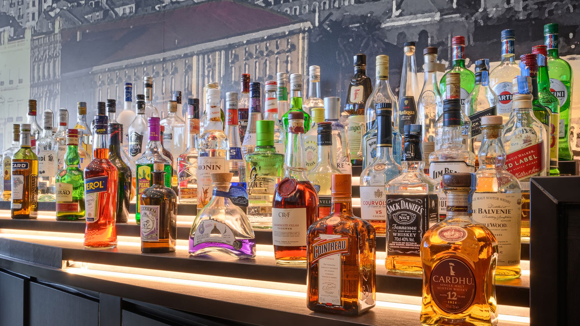 a group of bottles of alcohol on a shelf