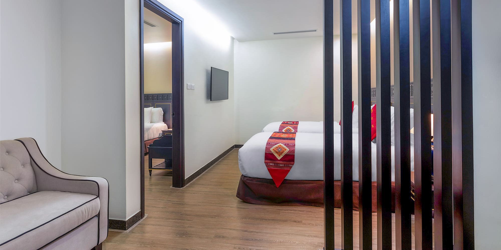 a room with two beds and a tv