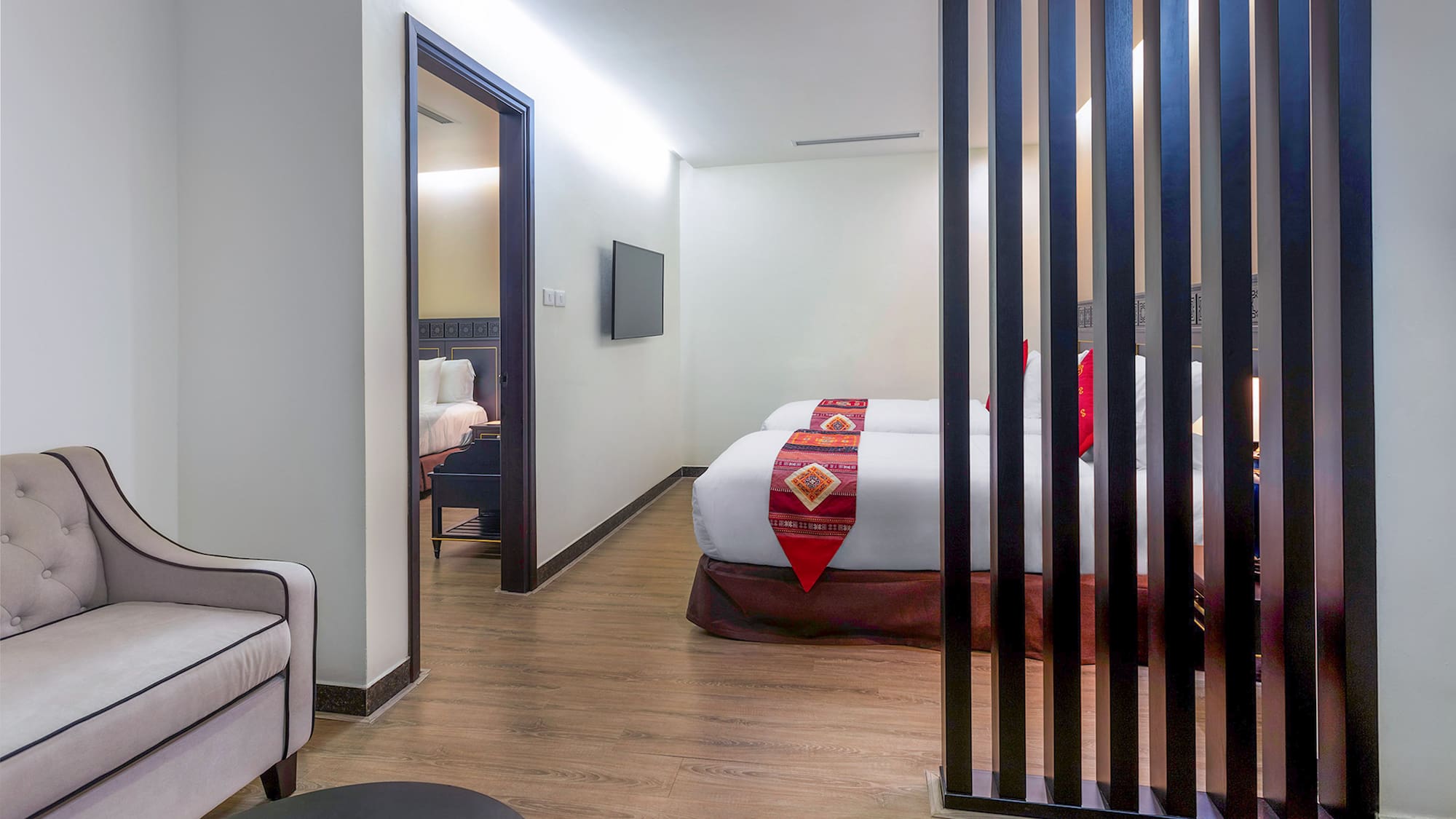 a room with two beds and a tv