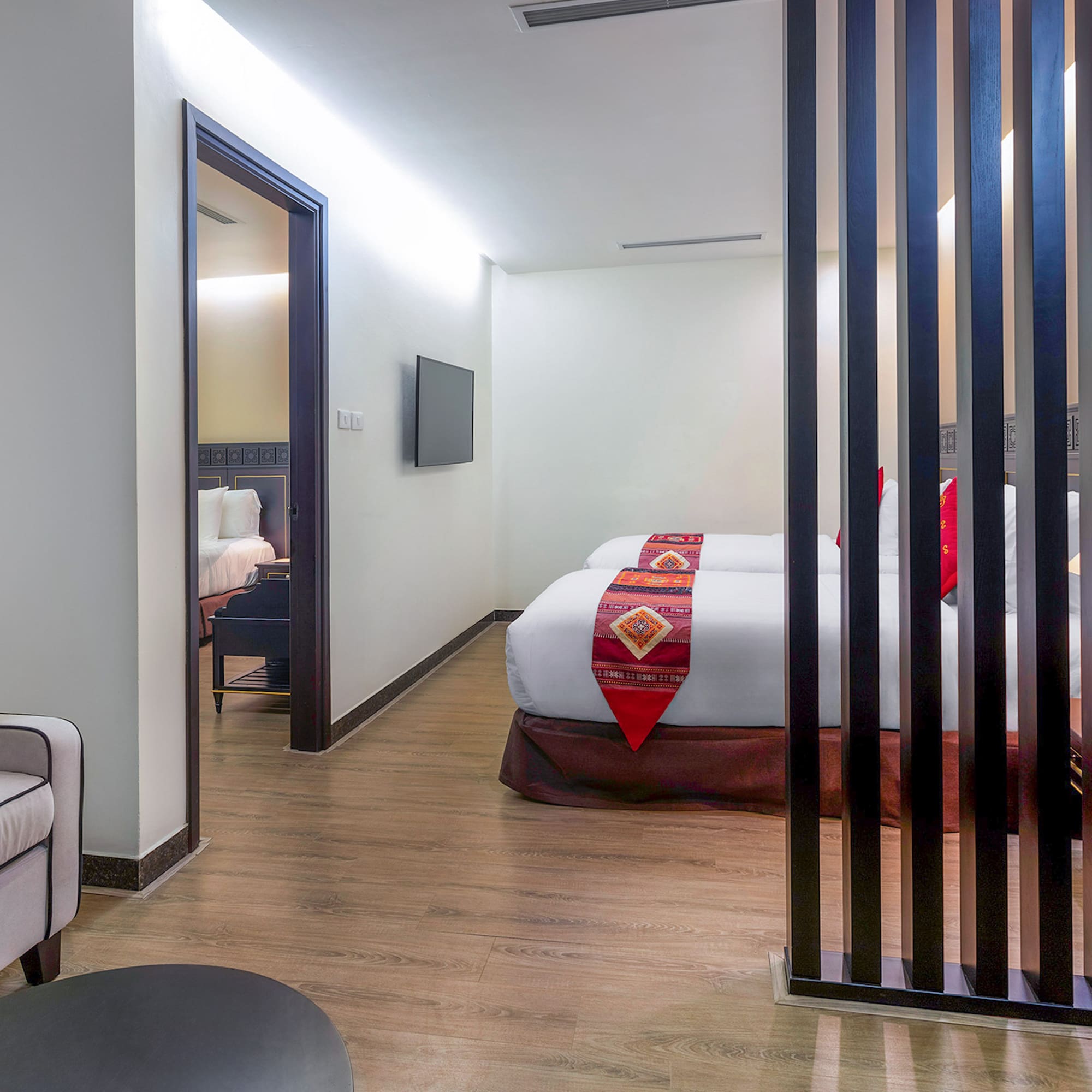 a room with two beds and a tv