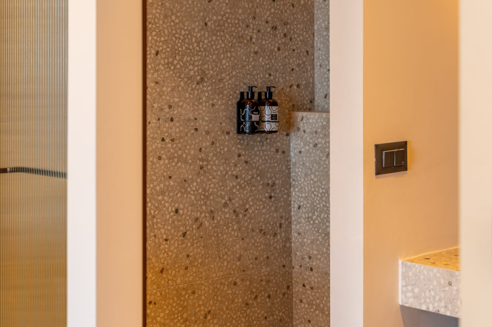 a shower with a shower and a sink