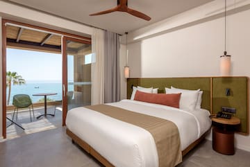 a bed with a fan and a ceiling fan.