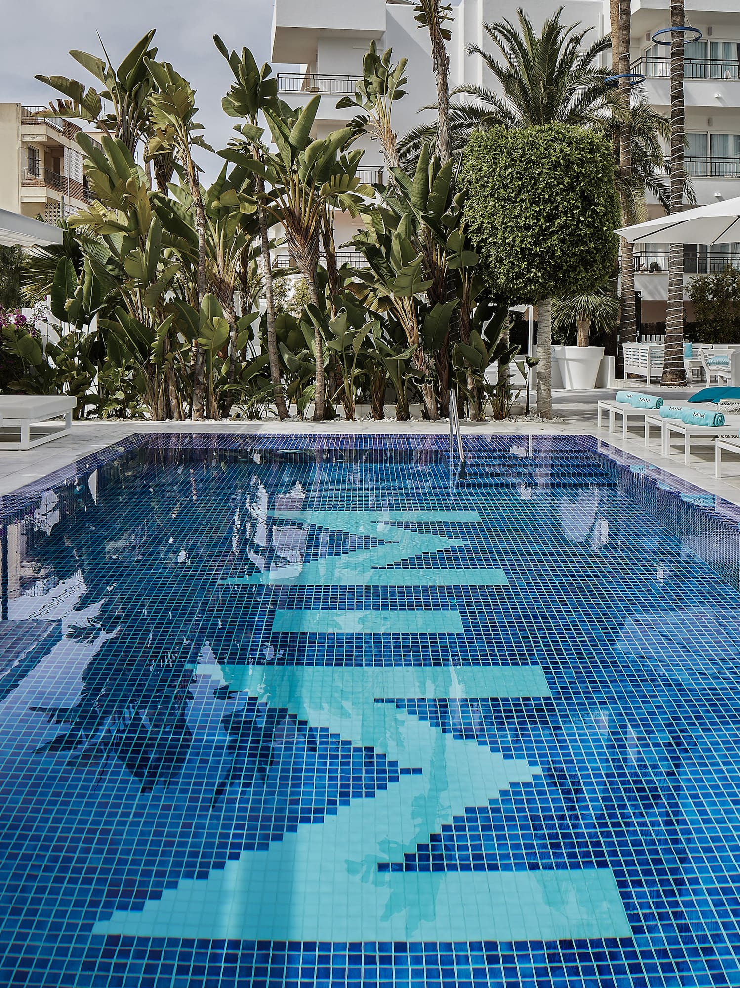 a pool with chairs and umbrellas