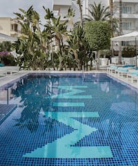 a pool with chairs and umbrellas