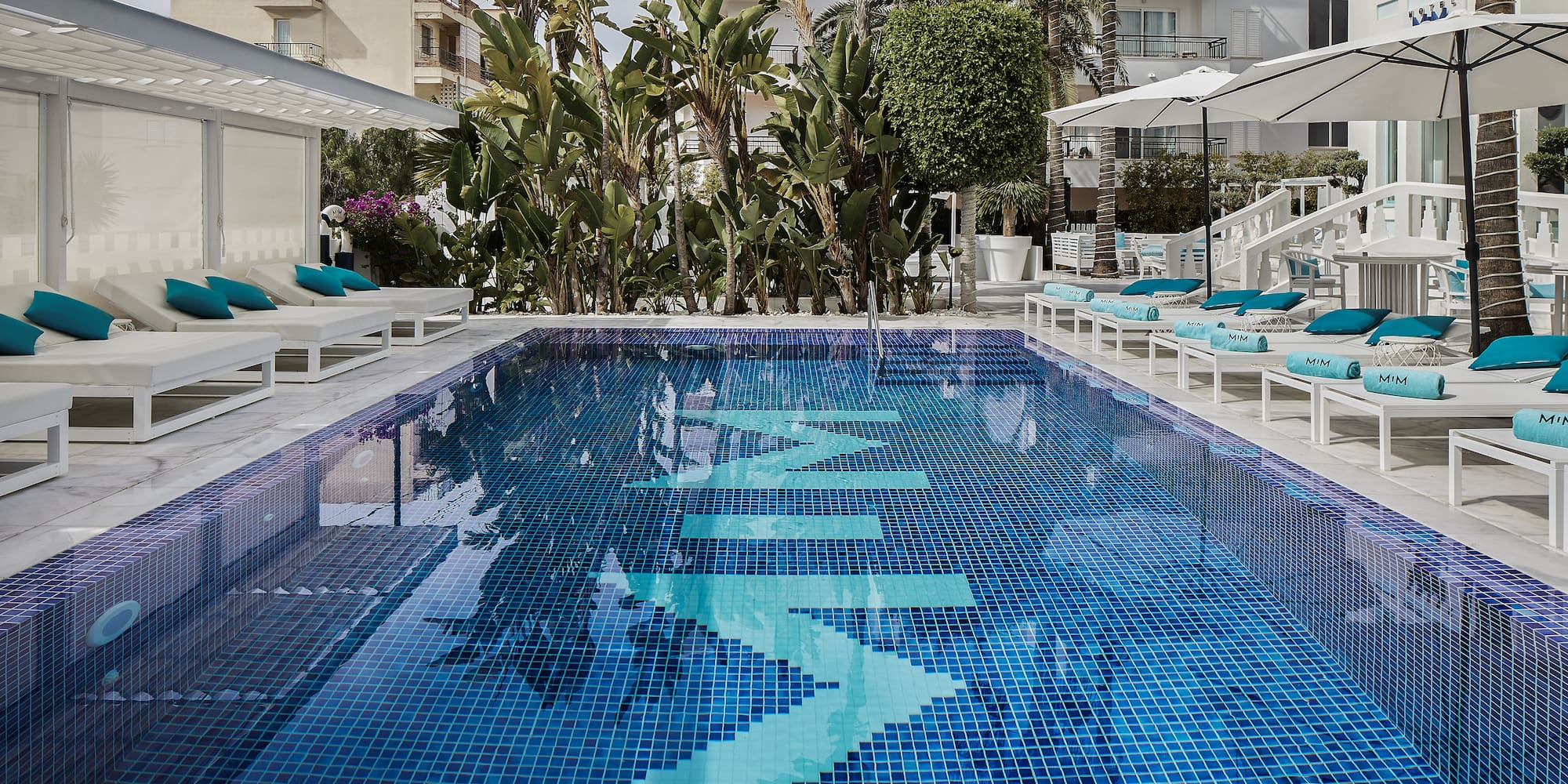 a pool with chairs and umbrellas