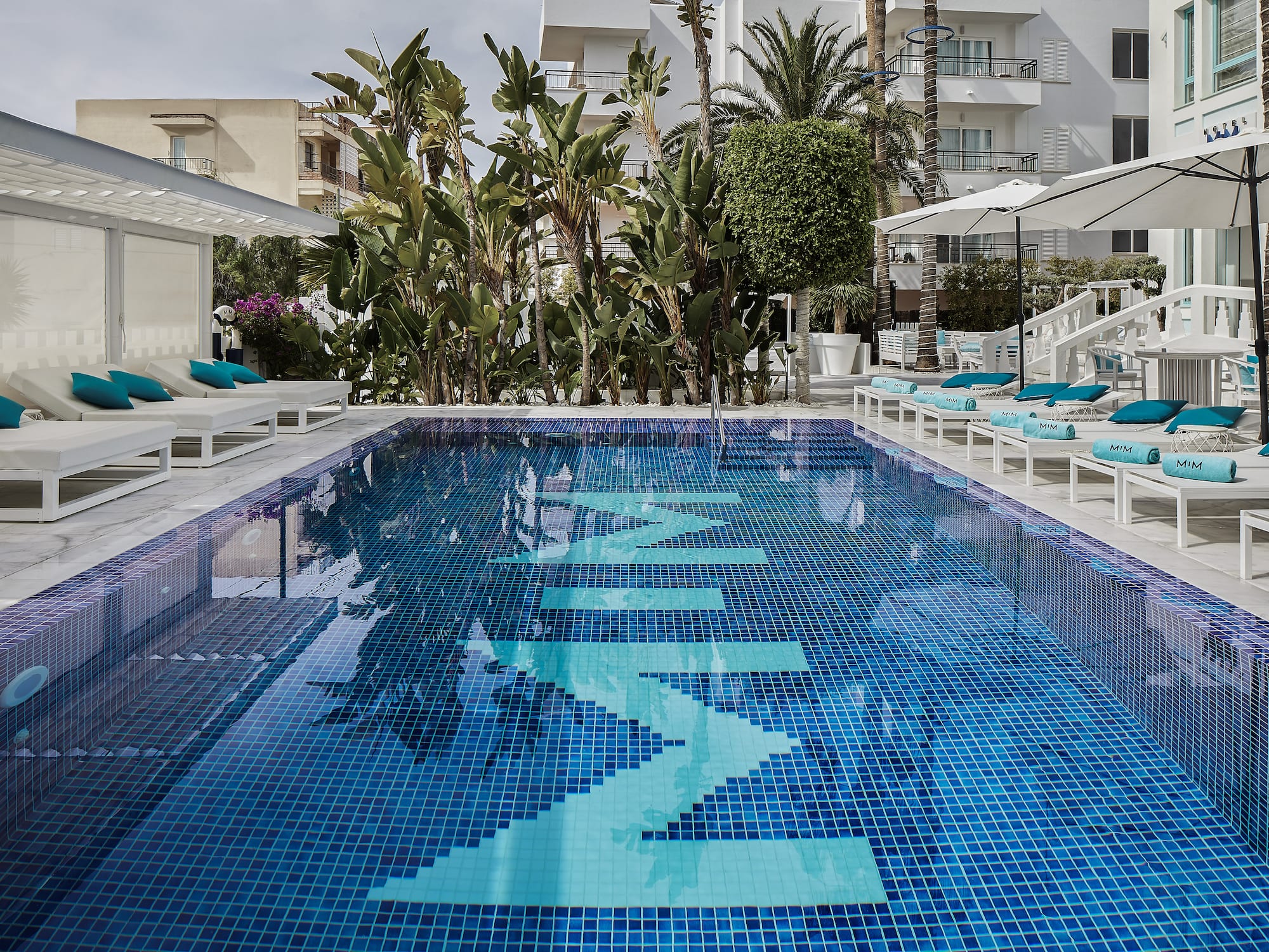 a pool with chairs and umbrellas