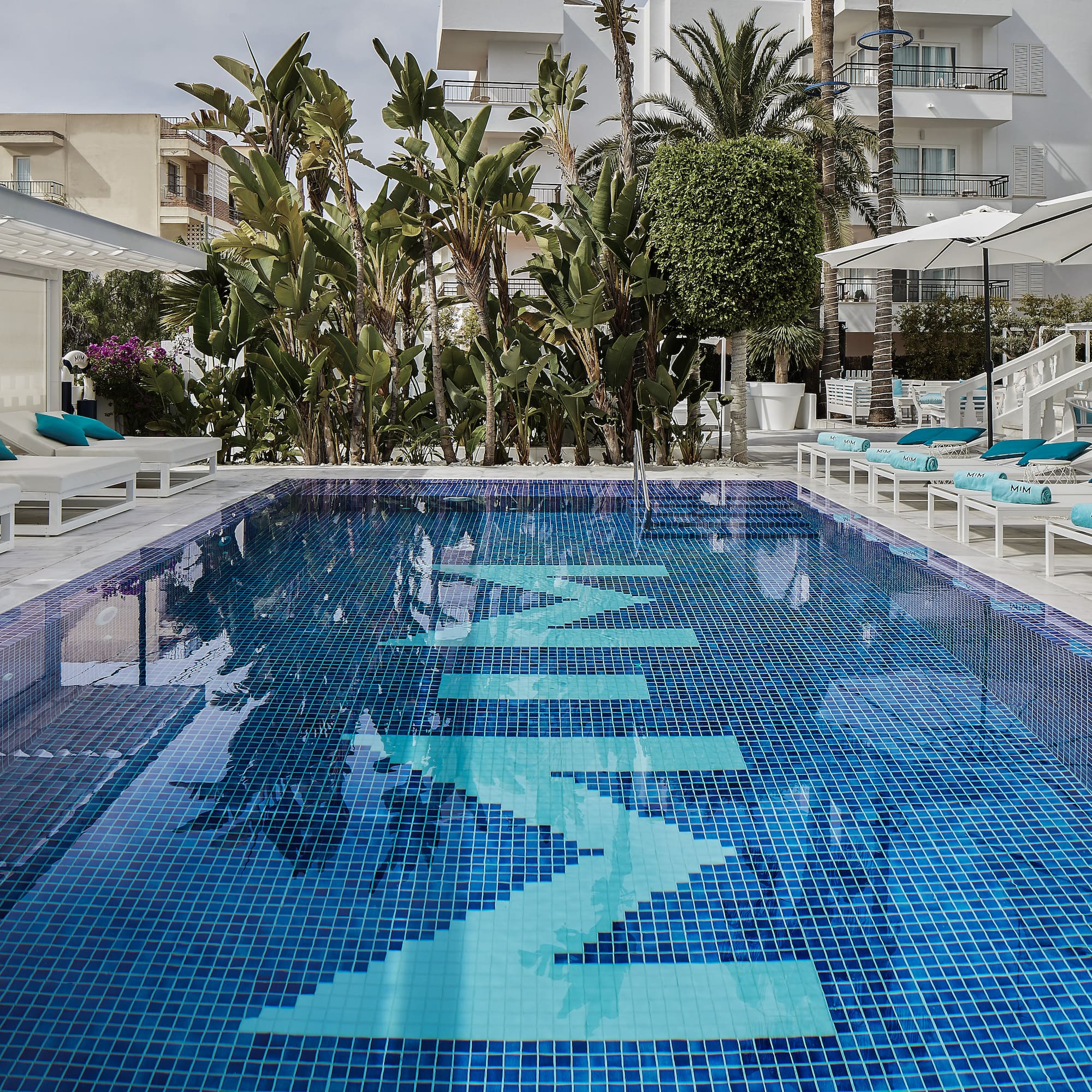 a pool with chairs and umbrellas