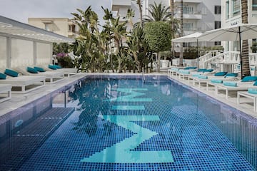 a pool with chairs and umbrellas