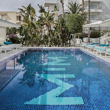 a pool with chairs and umbrellas