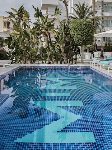 a pool with chairs and umbrellas