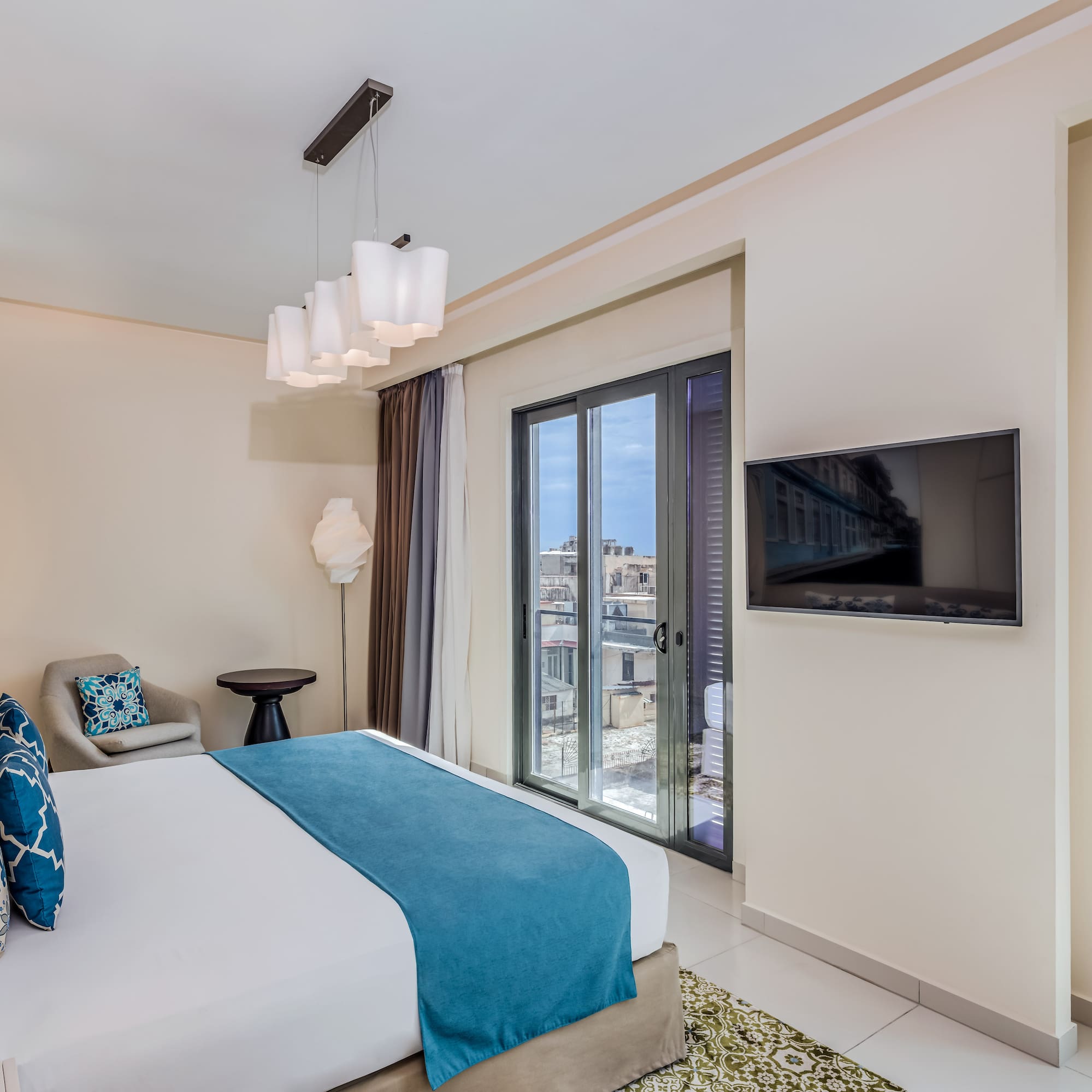 a bedroom with a bed and a television