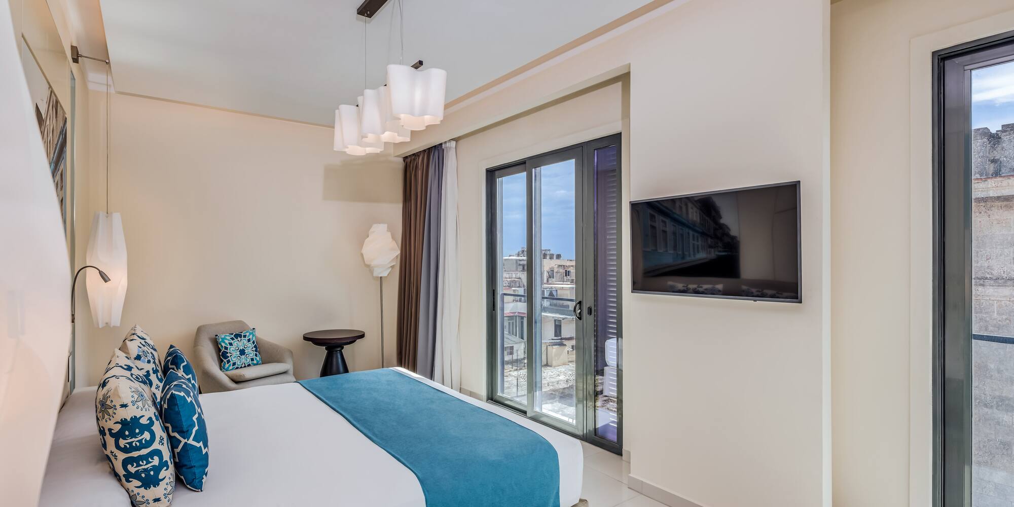 a bedroom with a bed and a television