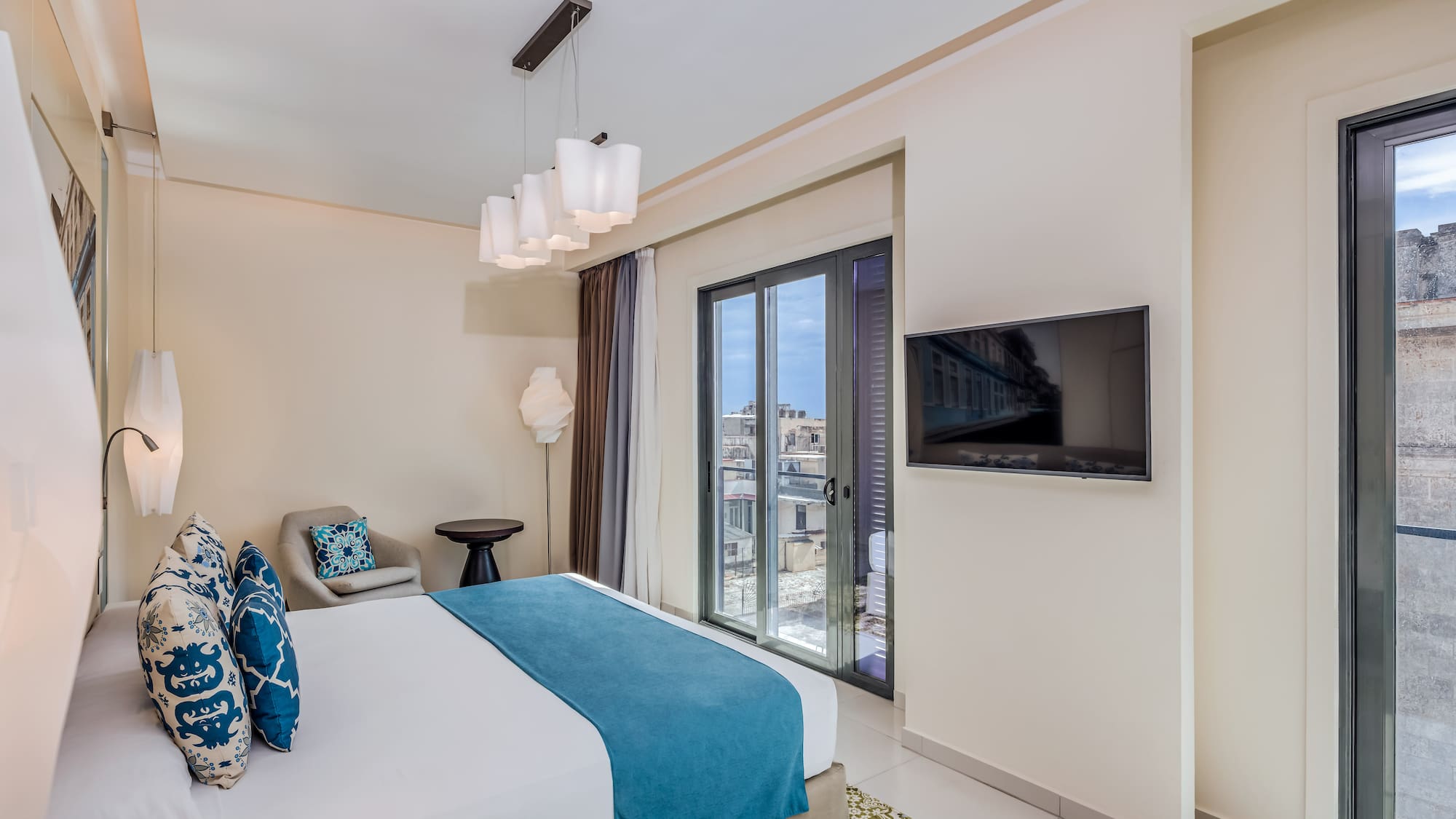 a bedroom with a bed and a television