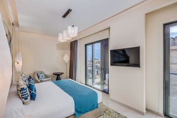 a bedroom with a bed and a television