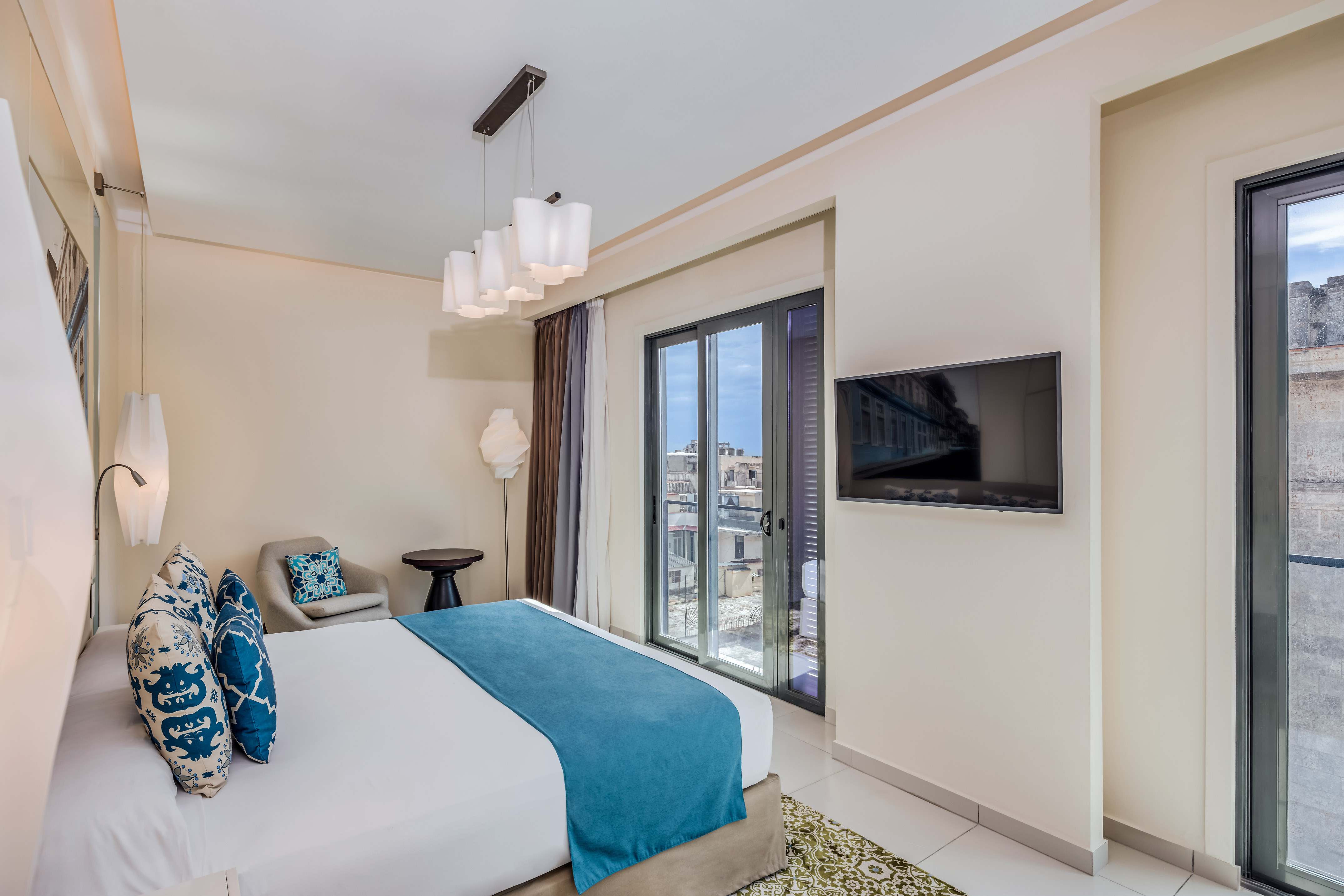 a bedroom with a bed and a television