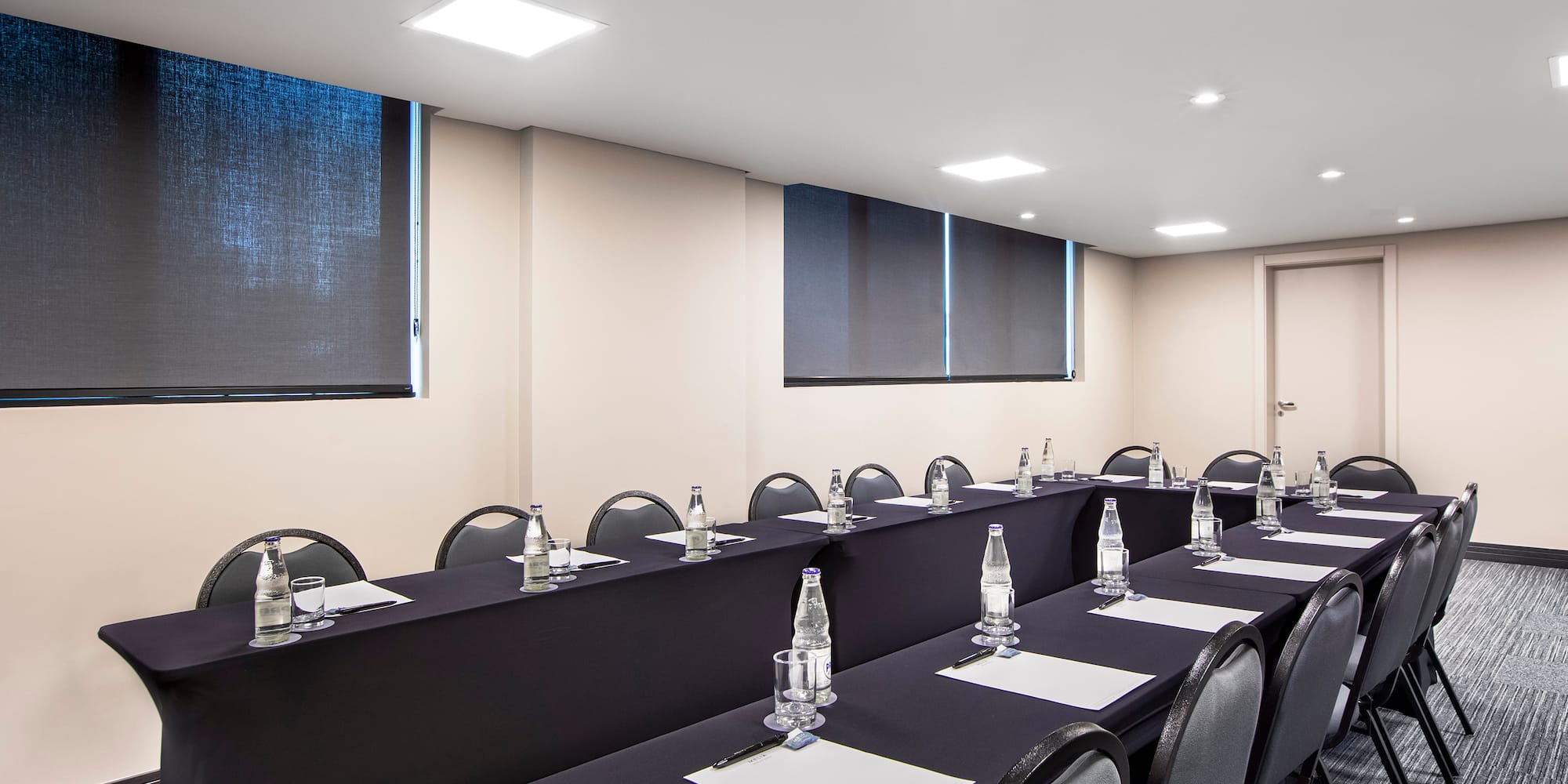 a room with long tables and chairs