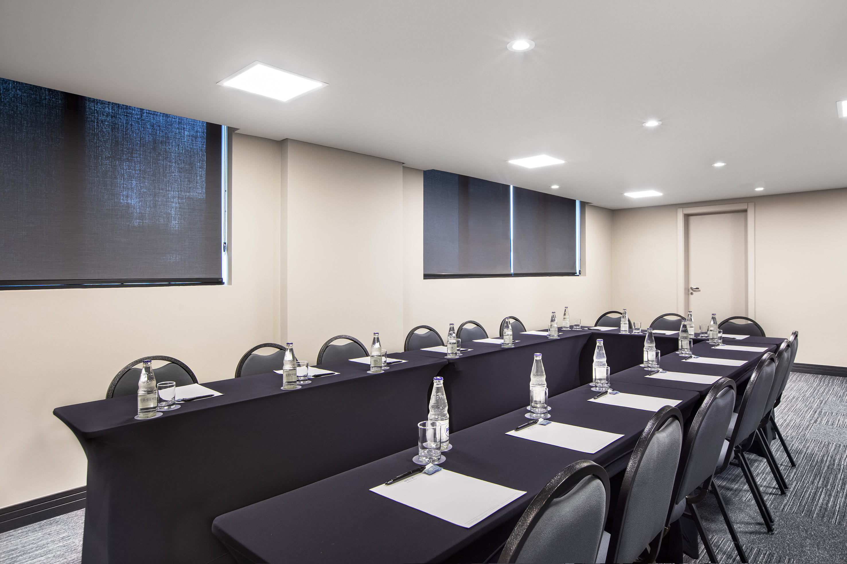 a room with long tables and chairs