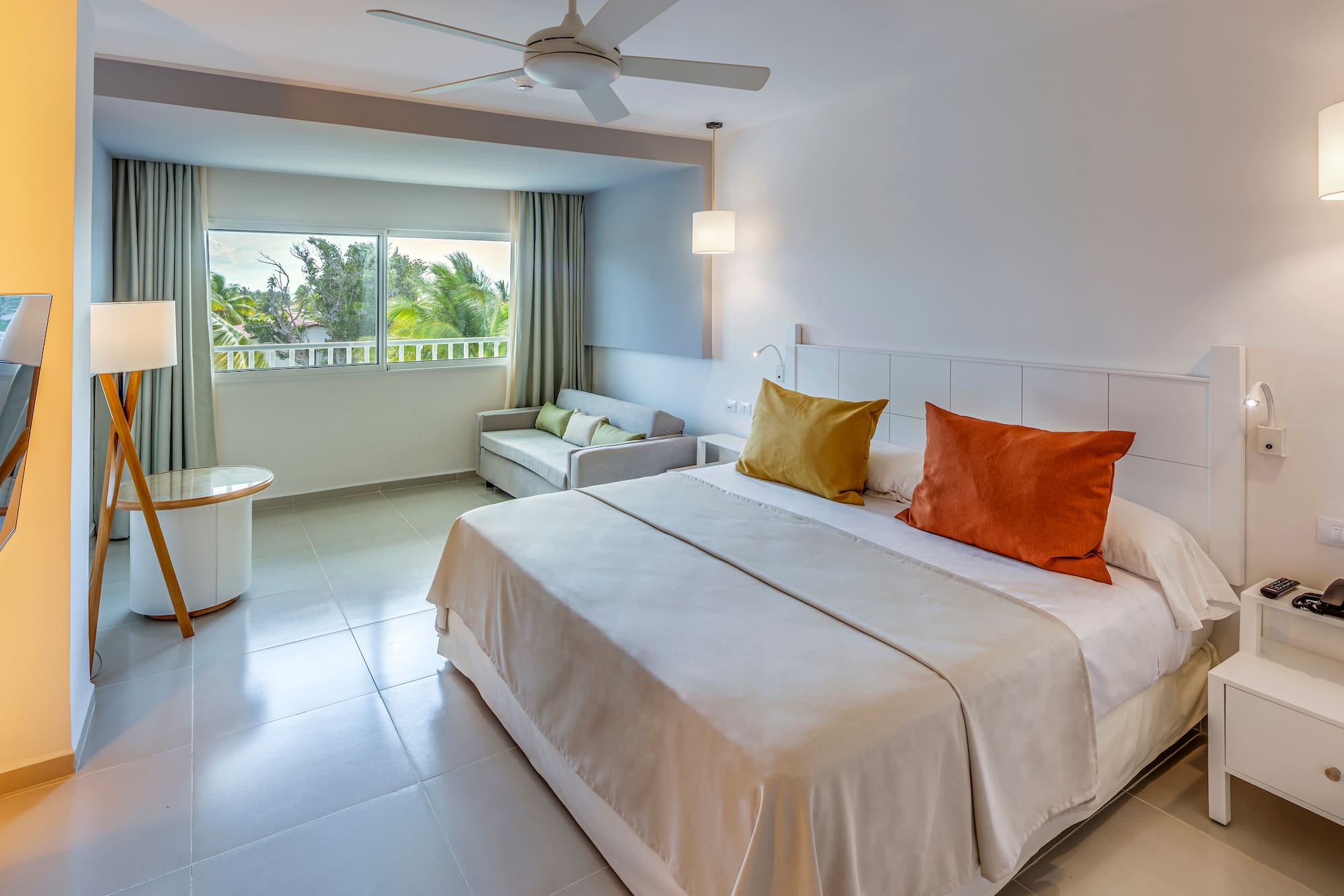 a bedroom with a bed and a ceiling fan