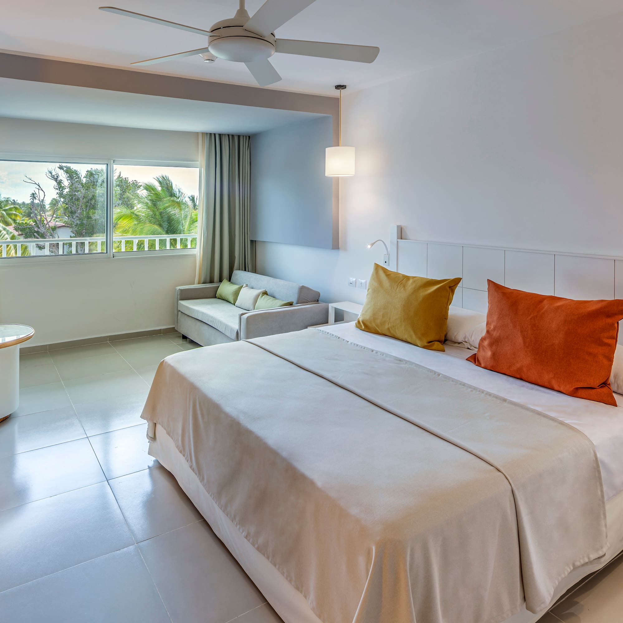 a bedroom with a bed and a ceiling fan