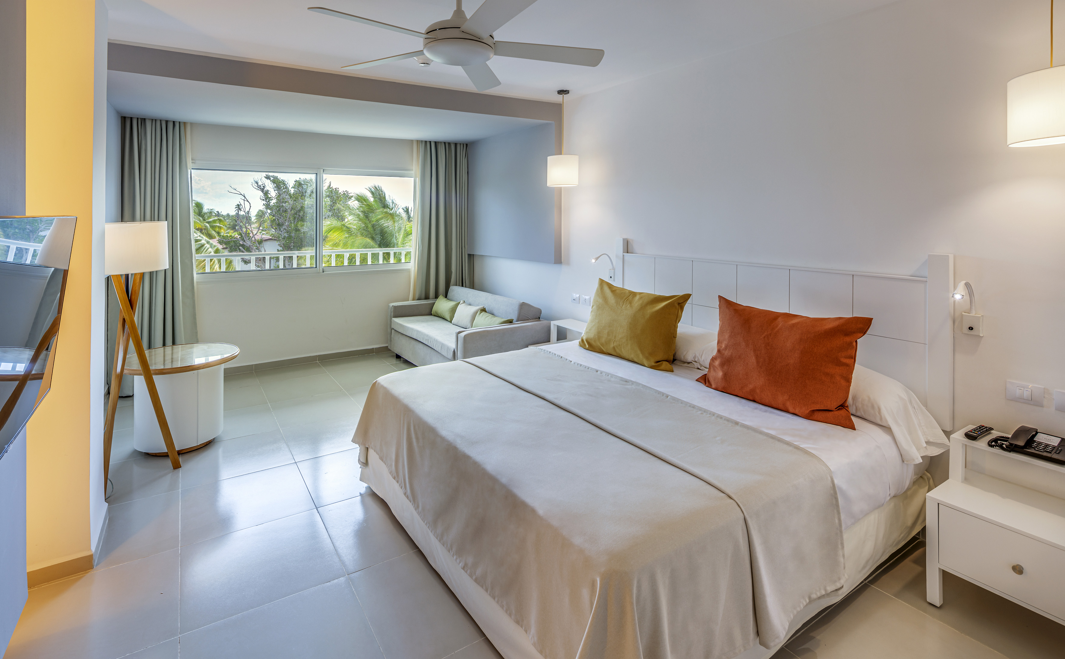 a bedroom with a bed and a ceiling fan