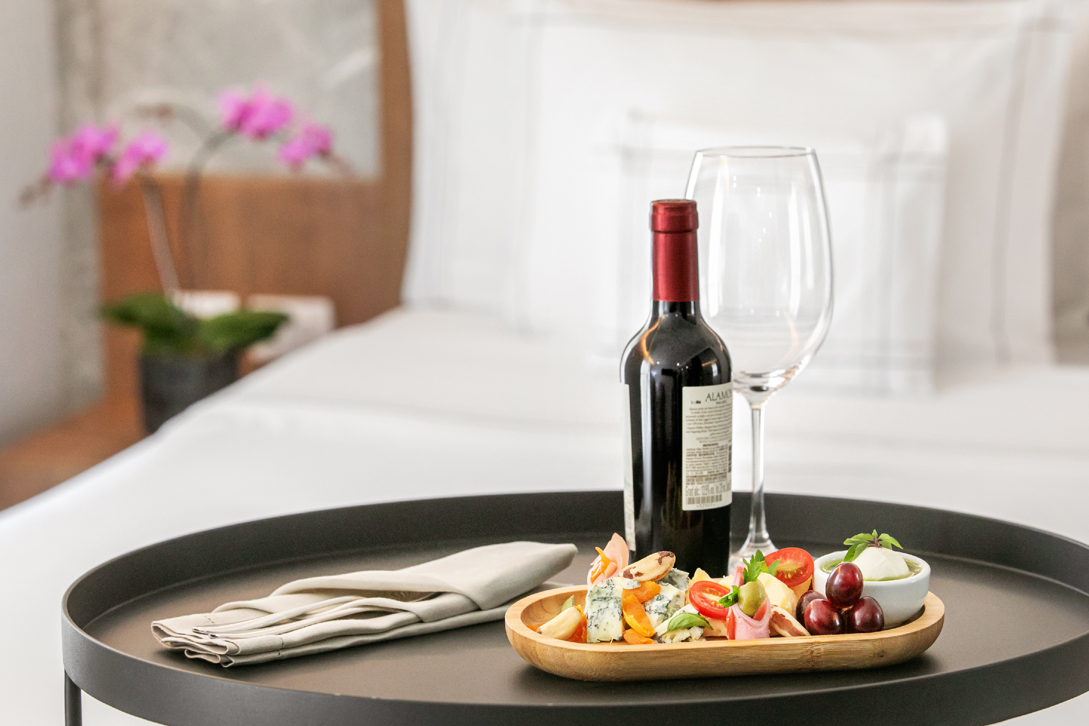 a wine bottle and a plate of food on a tray