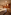 Inviting spa massage room with two tables, warm lighting, and wood accent wall.