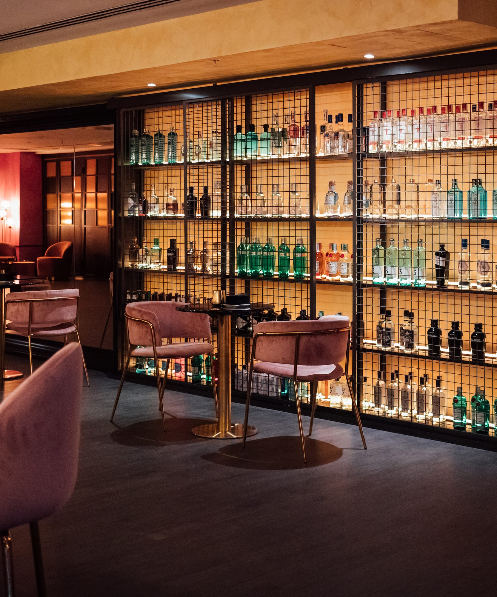 a room with a bar and a shelf with bottles of alcohol