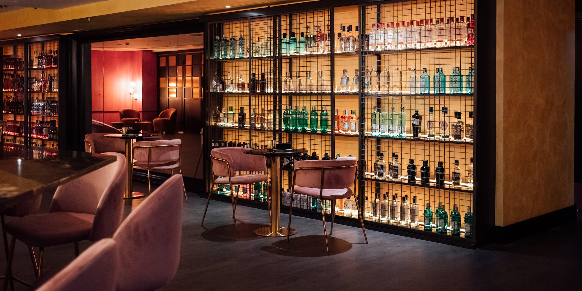 a room with a bar and a shelf with bottles of alcohol