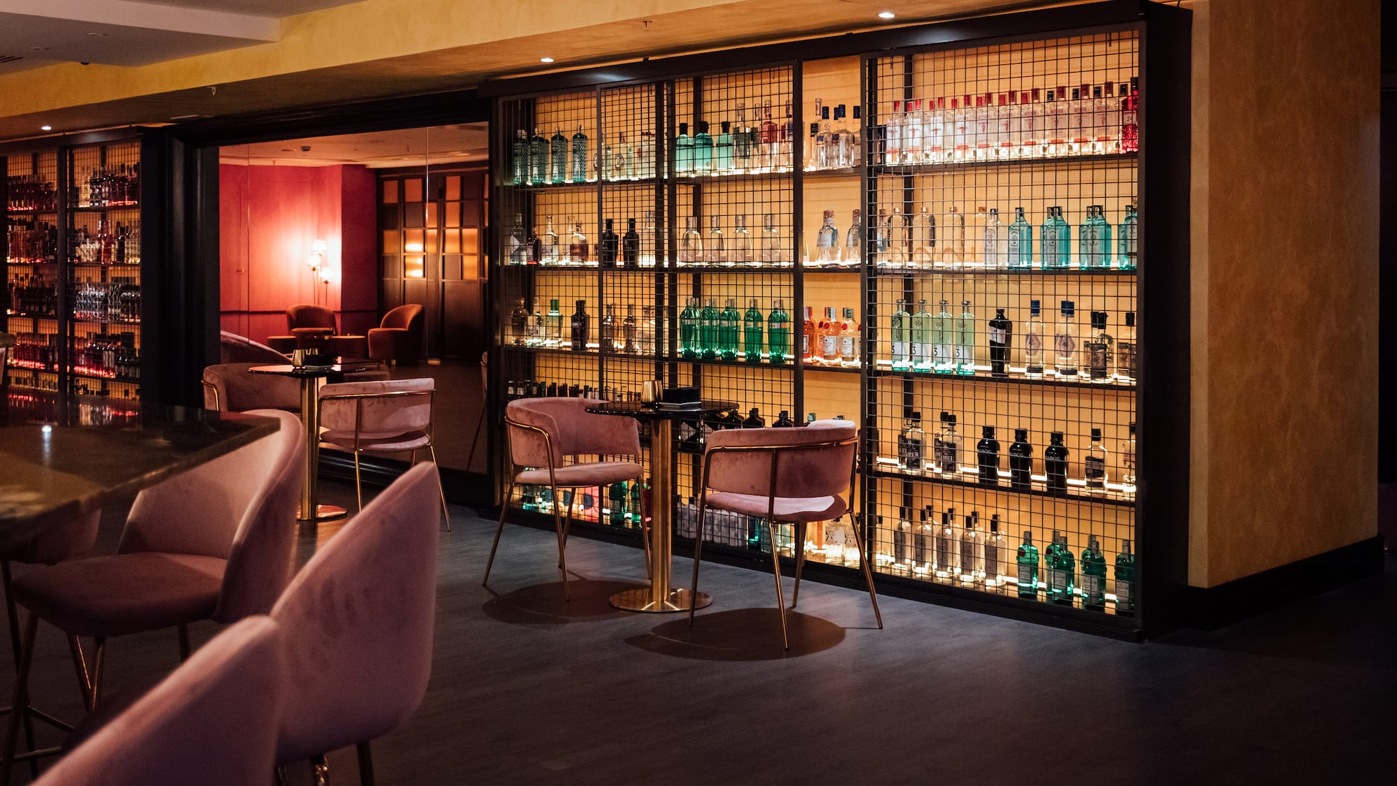 a room with a bar and a shelf with bottles of alcohol