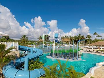 a water park with a slide and a pool