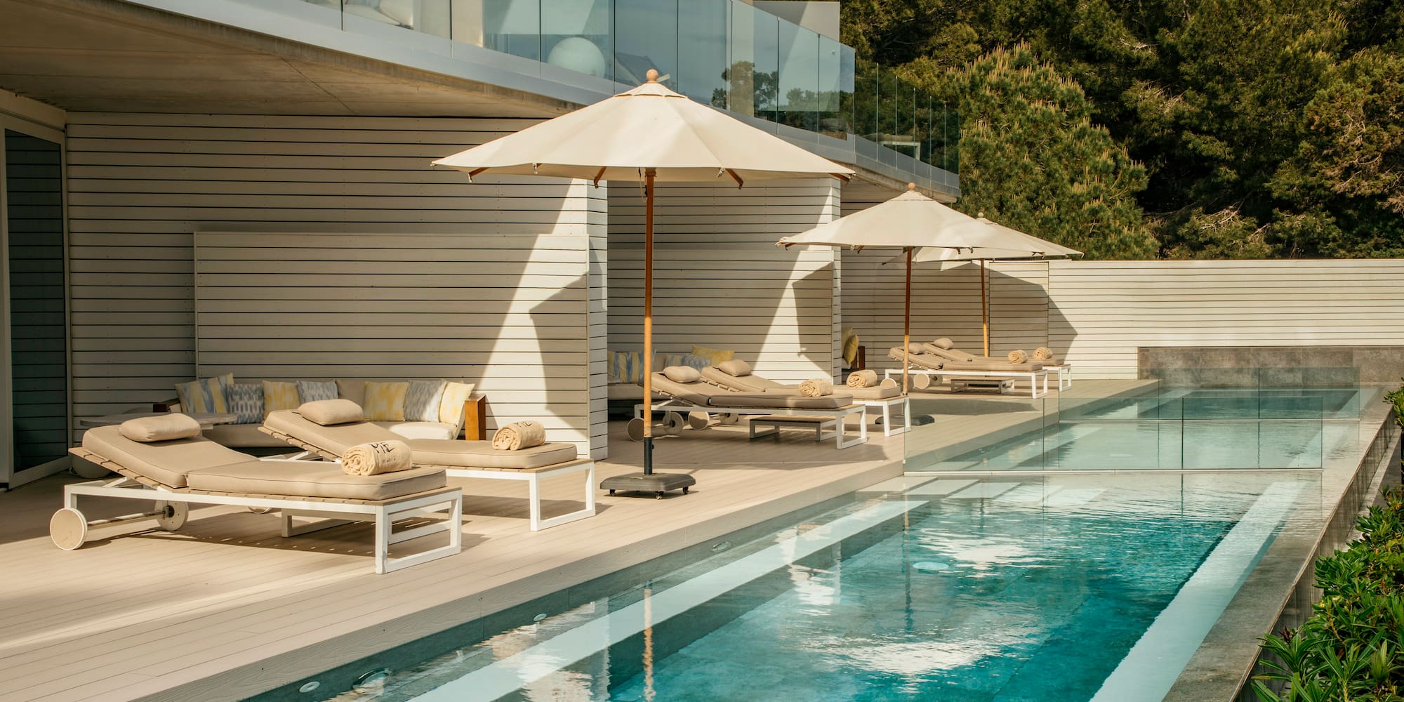 a pool with lounge chairs and umbrellas