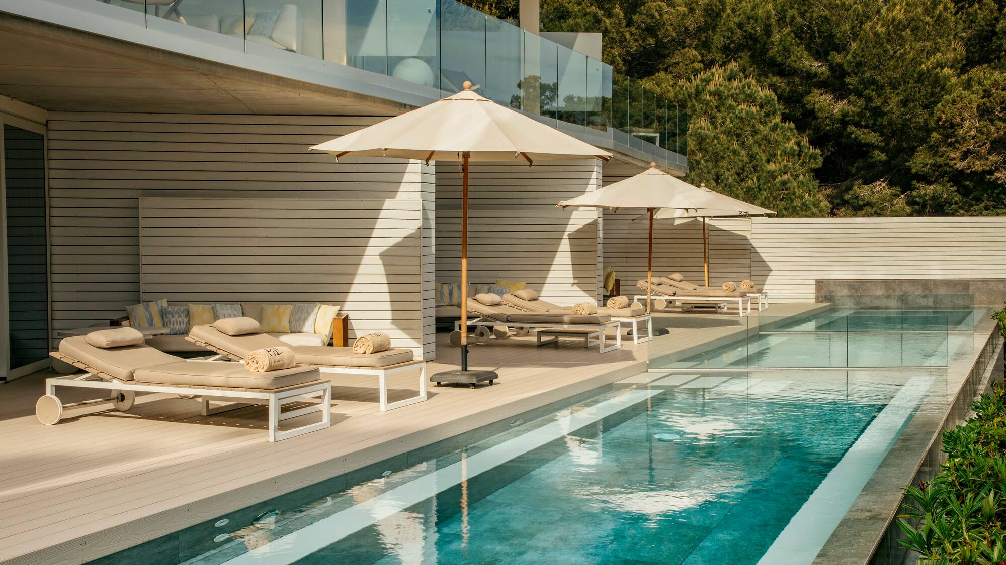 a pool with lounge chairs and umbrellas