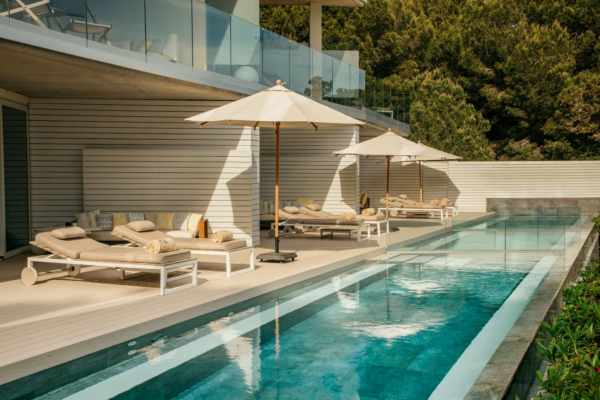 a pool with lounge chairs and umbrellas