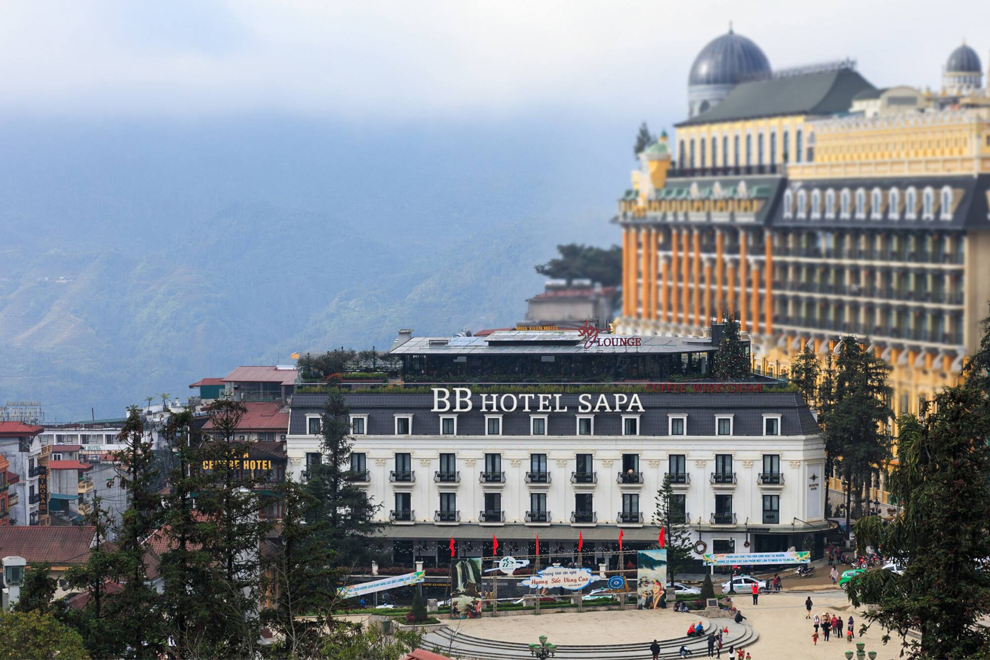 BB Hotel Sapa, Sapa town square, and misty mountains in Vietnam.