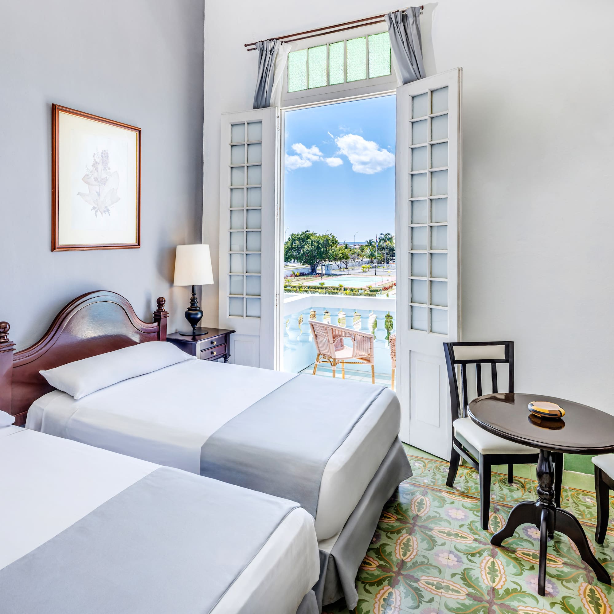 a room with two beds and a table