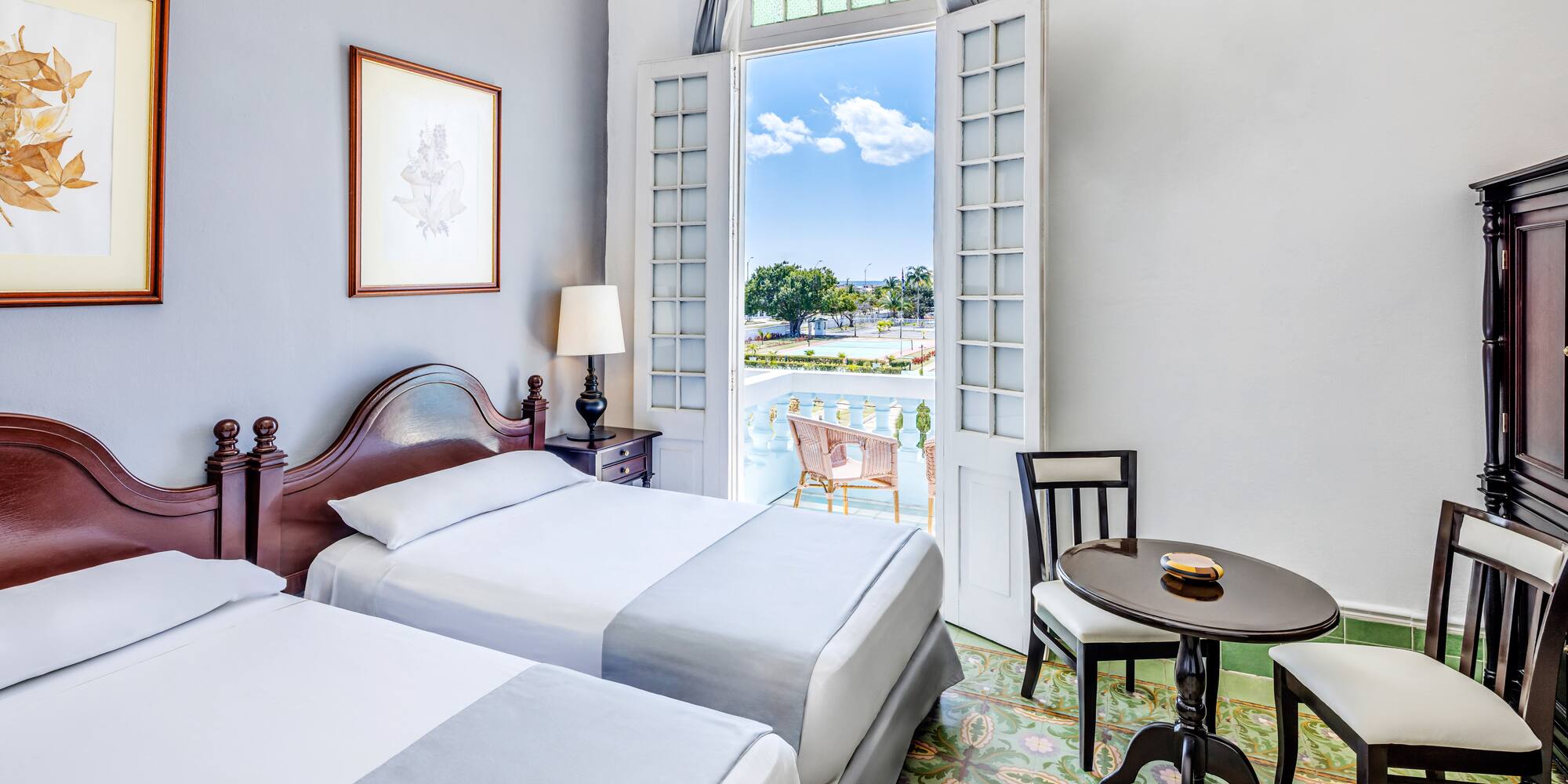 a room with two beds and a table