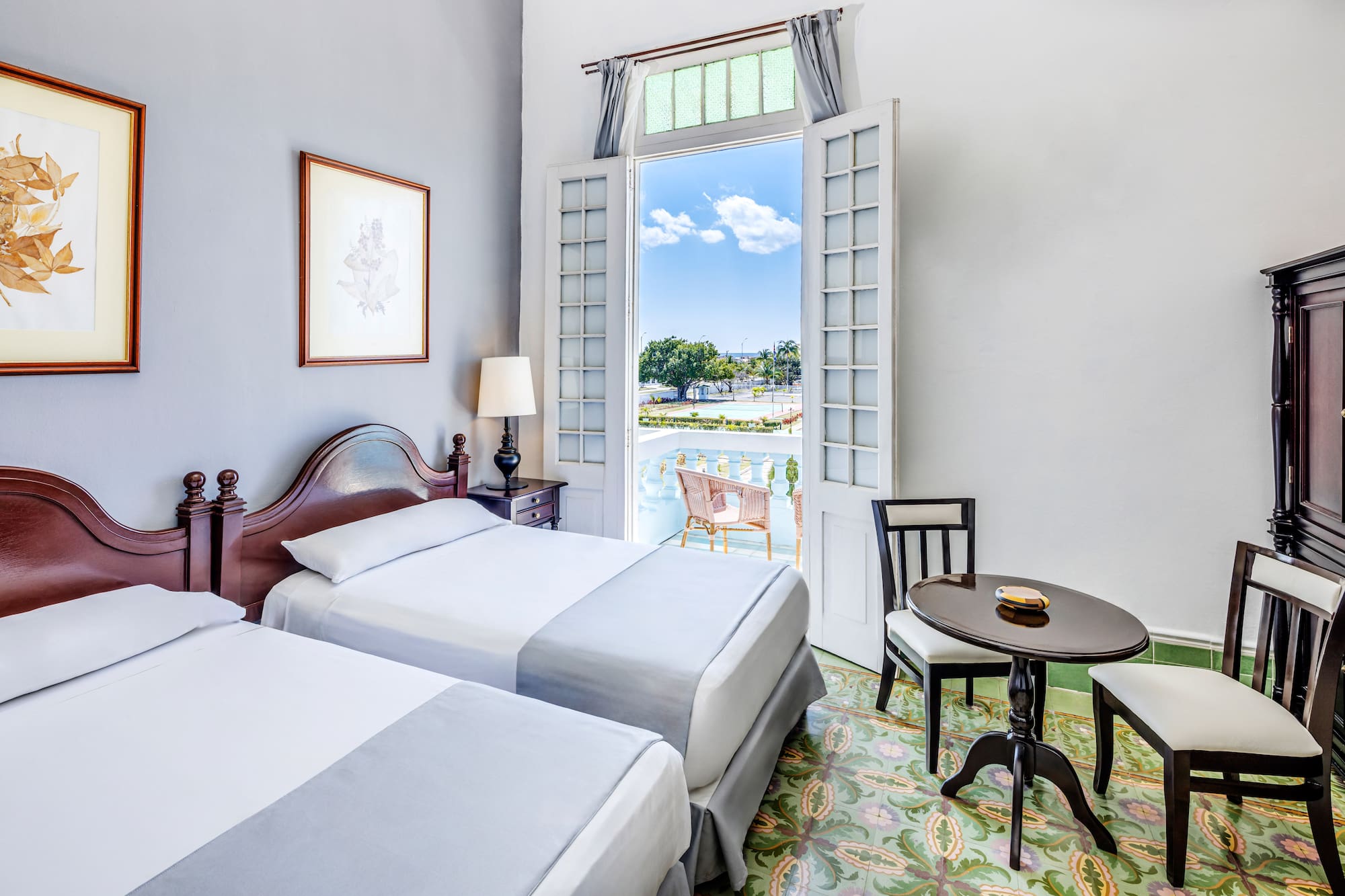 a room with two beds and a table