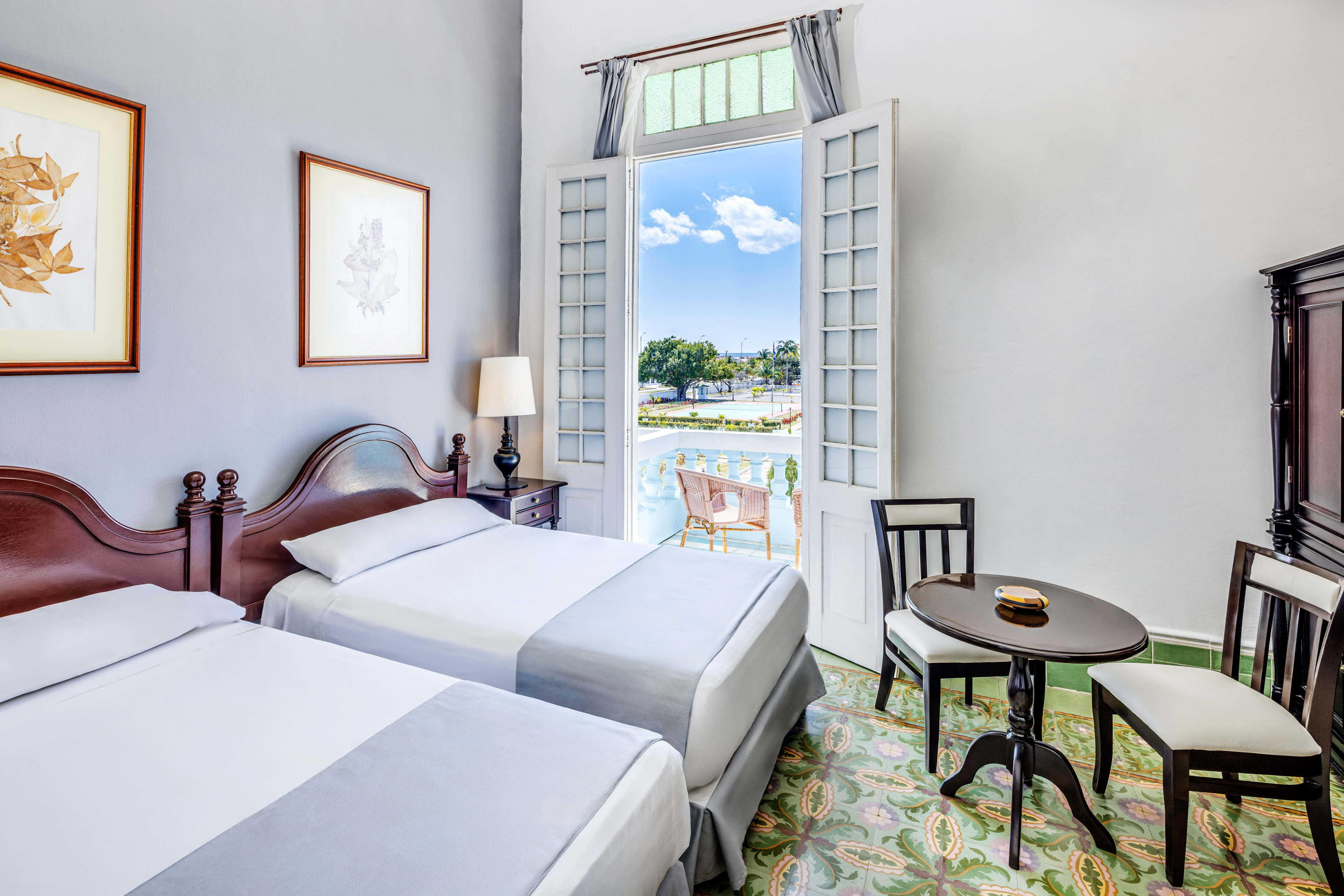 a room with two beds and a table