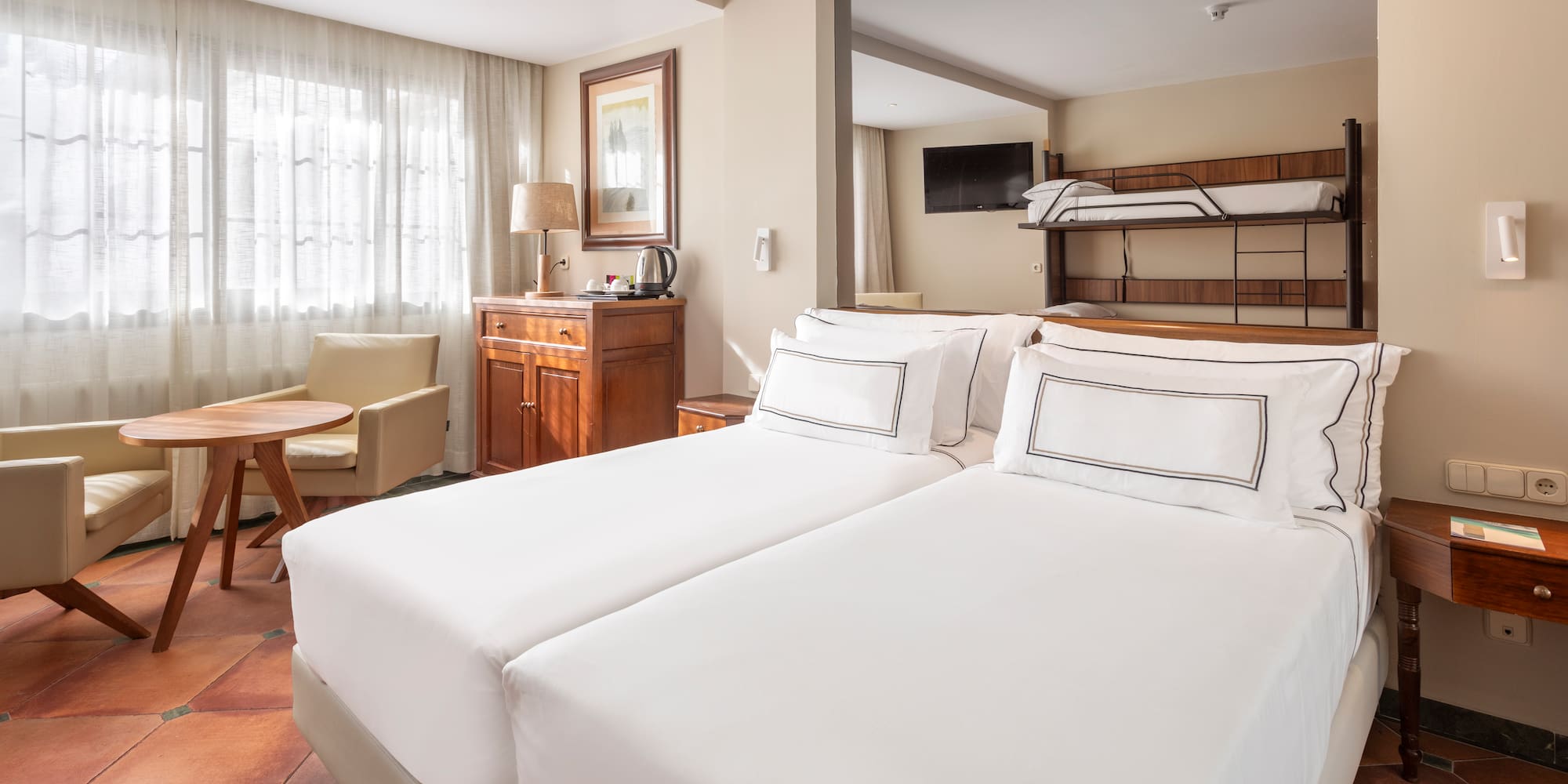 a room with two beds and a bunk bed