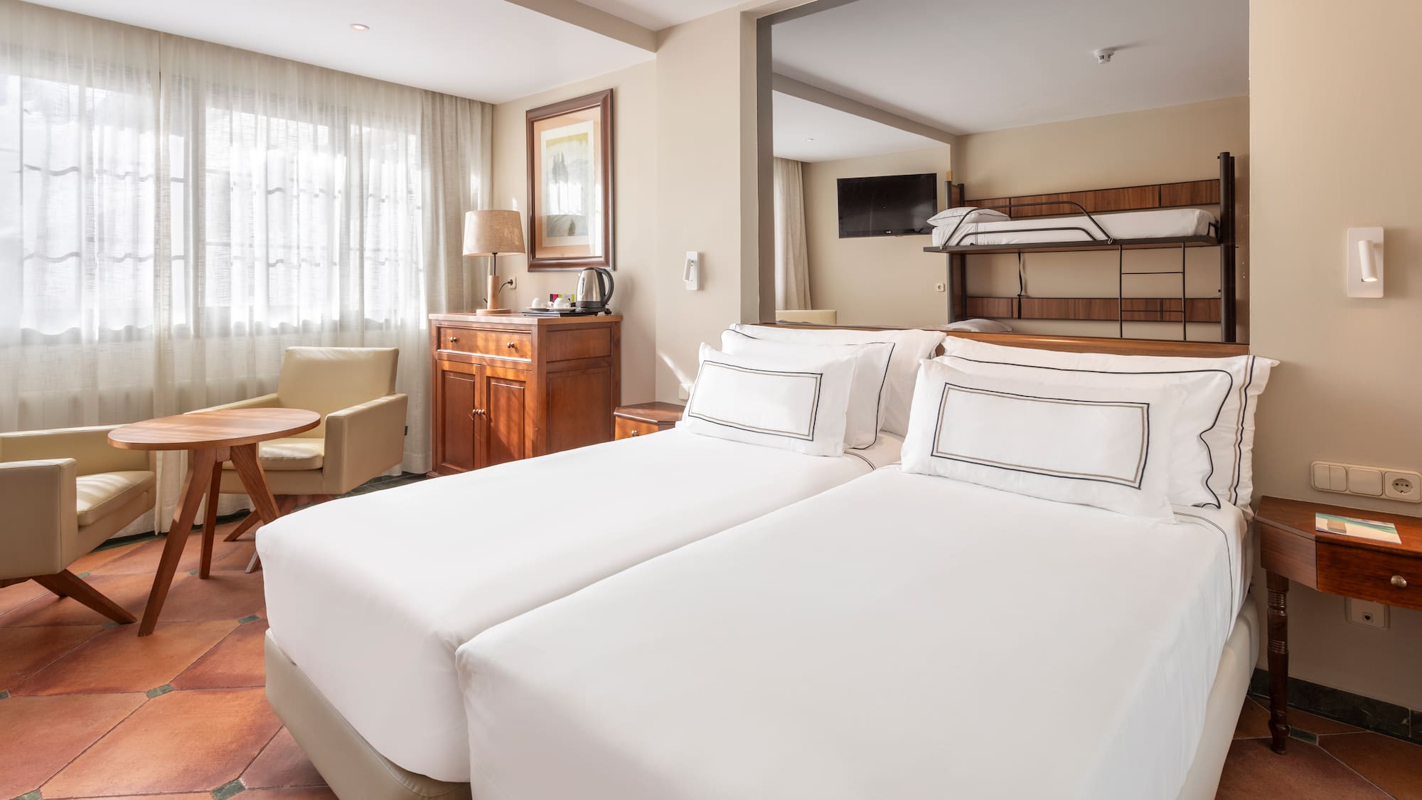 a room with two beds and a bunk bed